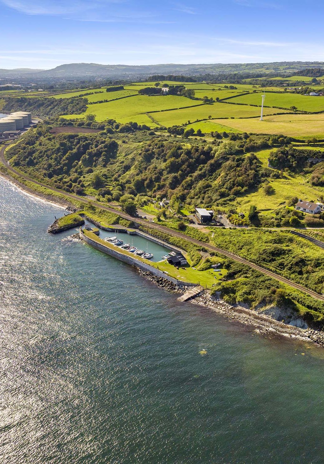 Drone shot of Whiteharbour with power station and Carrickfergus in the background